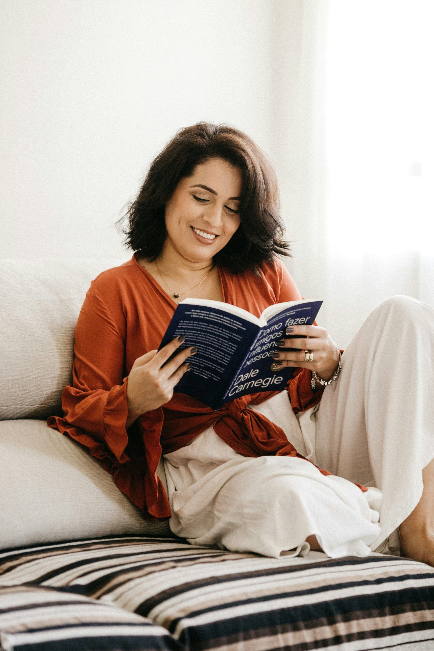 Woman reading a book on a bed