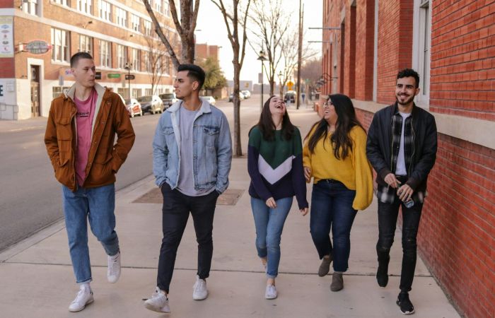 Young friends walking together in the city
